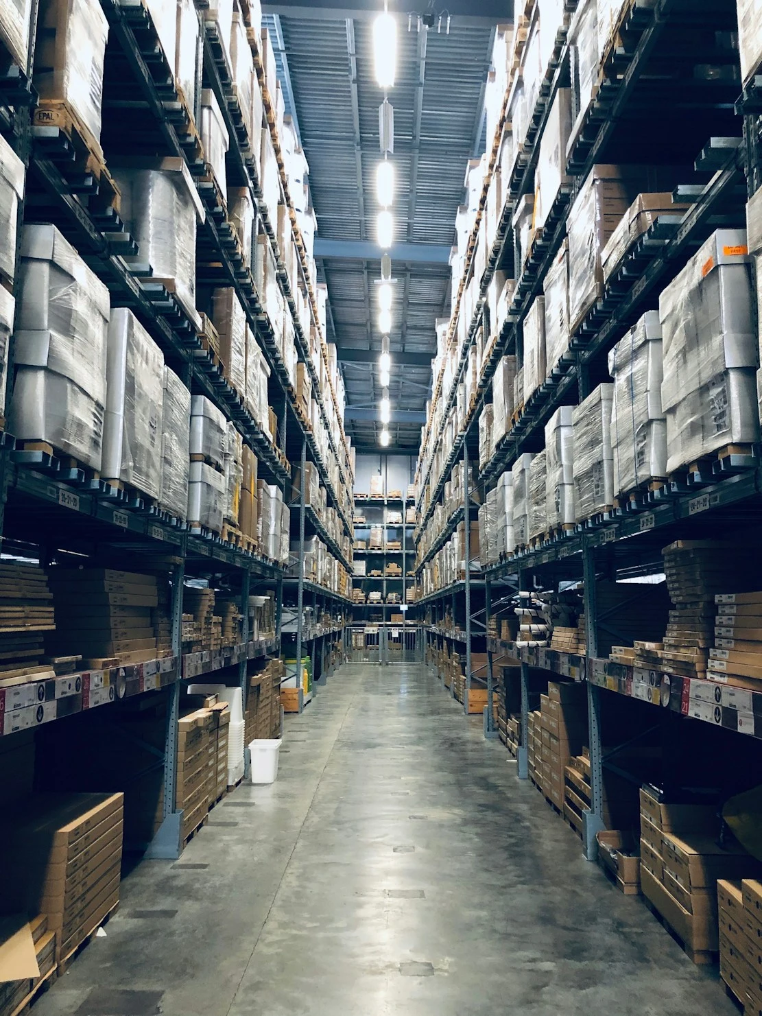 Warehouse aisle stacked with sealed inventory